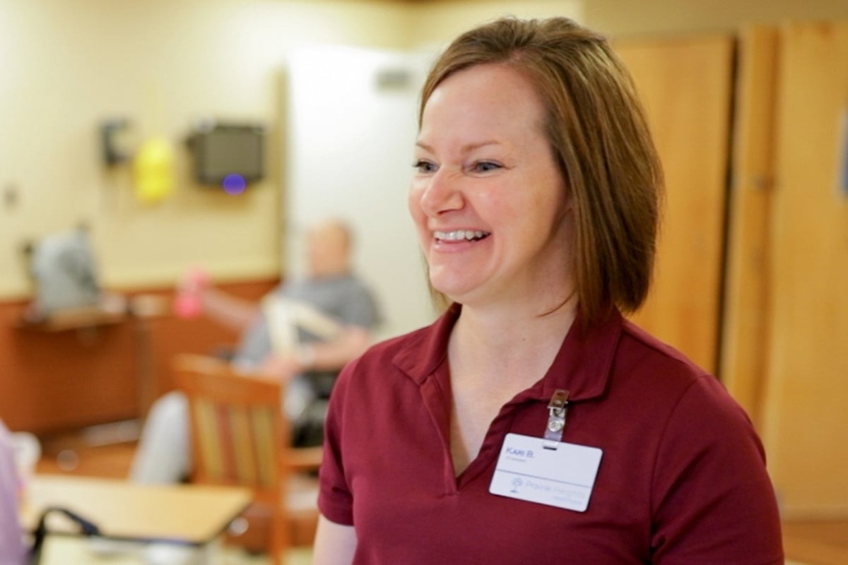 Smiling Prairie Heights team member in a resident care setting