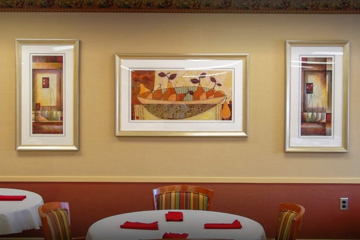 Framed artwork displayed above dining tables at Prairie Heights